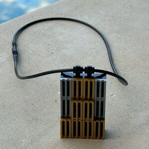Designer, LEGO (trademarked) pendant with stretchable necklace.